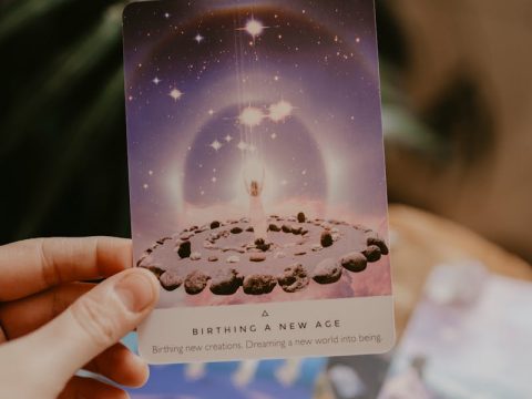 Tarot cards with candles and crystals in a mystical beginner setup